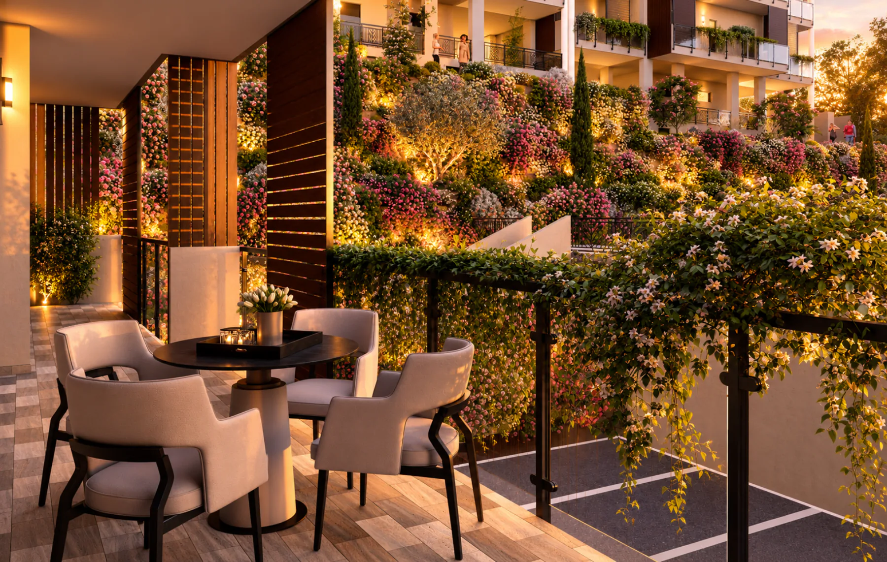 Terrazza con zona pranzo affacciata sui giardini fioriti al tramonto